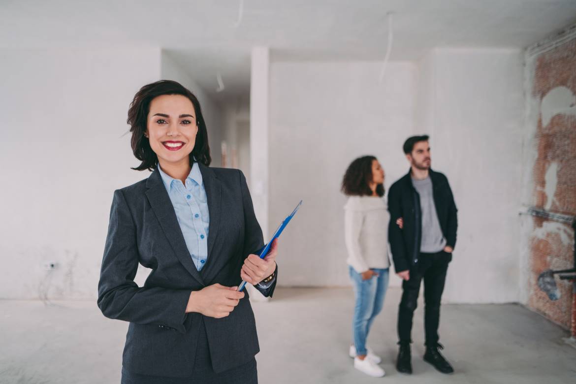 Real estate agent showing couple house