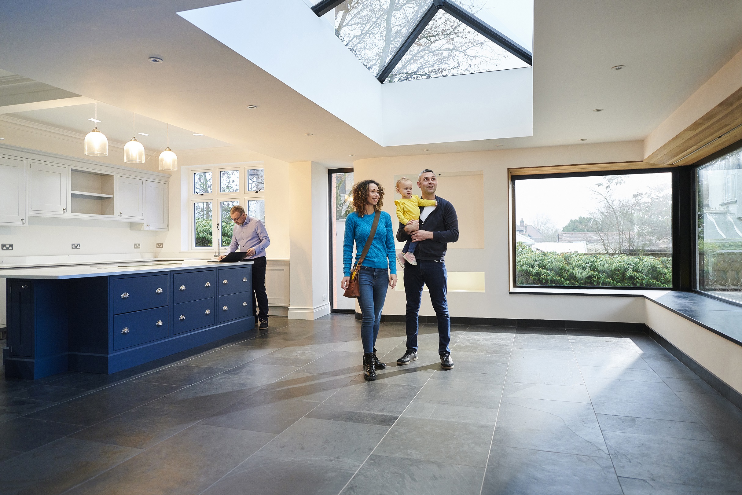 Couple with child viewing a kitchen in new home
