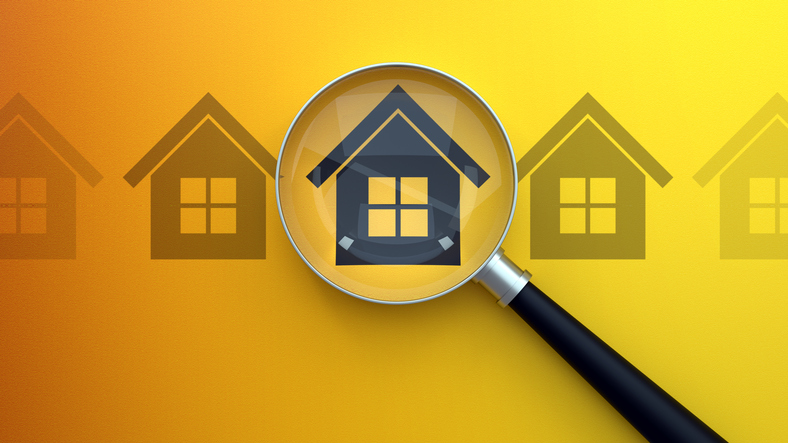 Image of house under magnifying glass